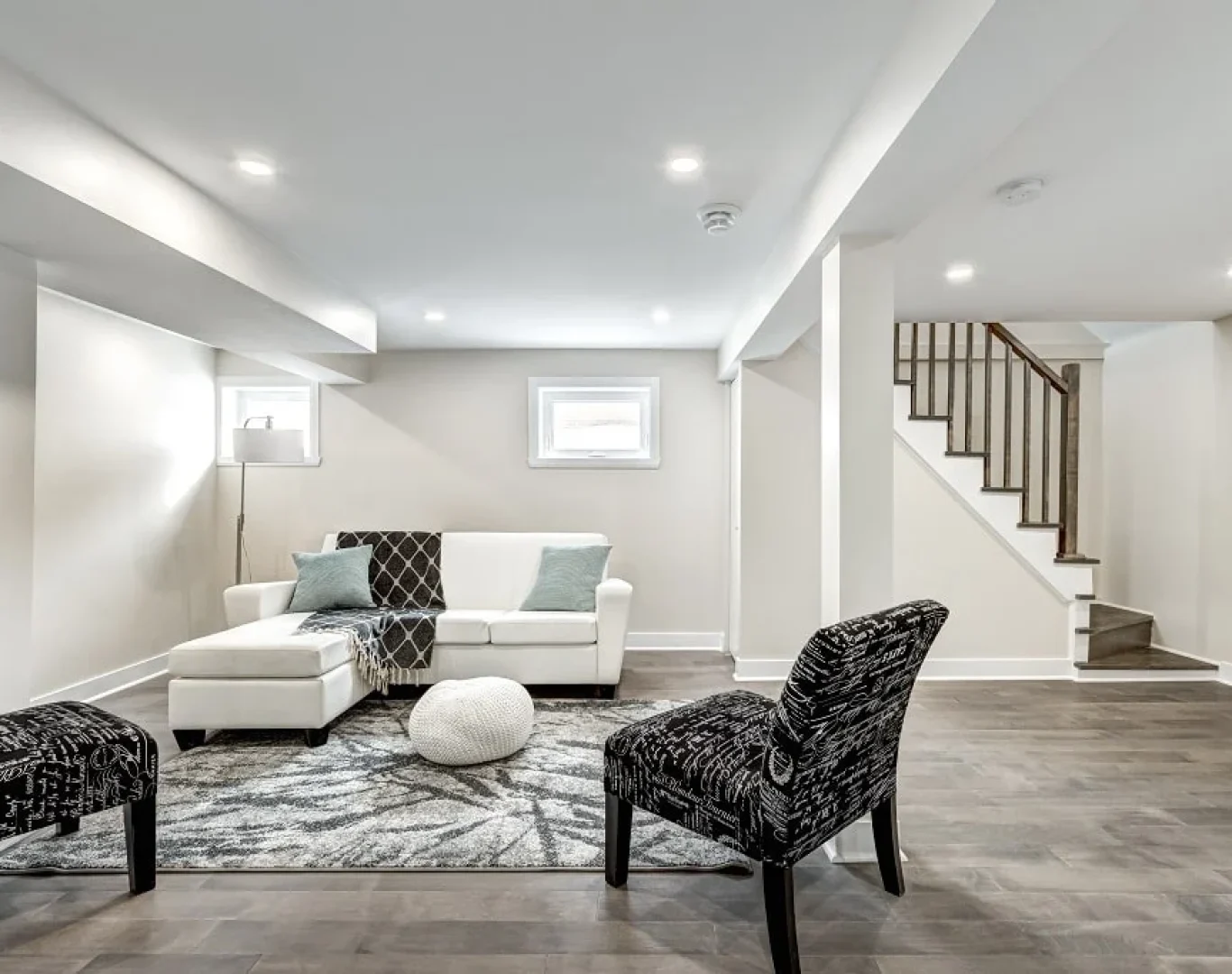 Finished basement renovation with new flooring, recessed lighting, and custom built-ins by Robin Construction in Novi, MI