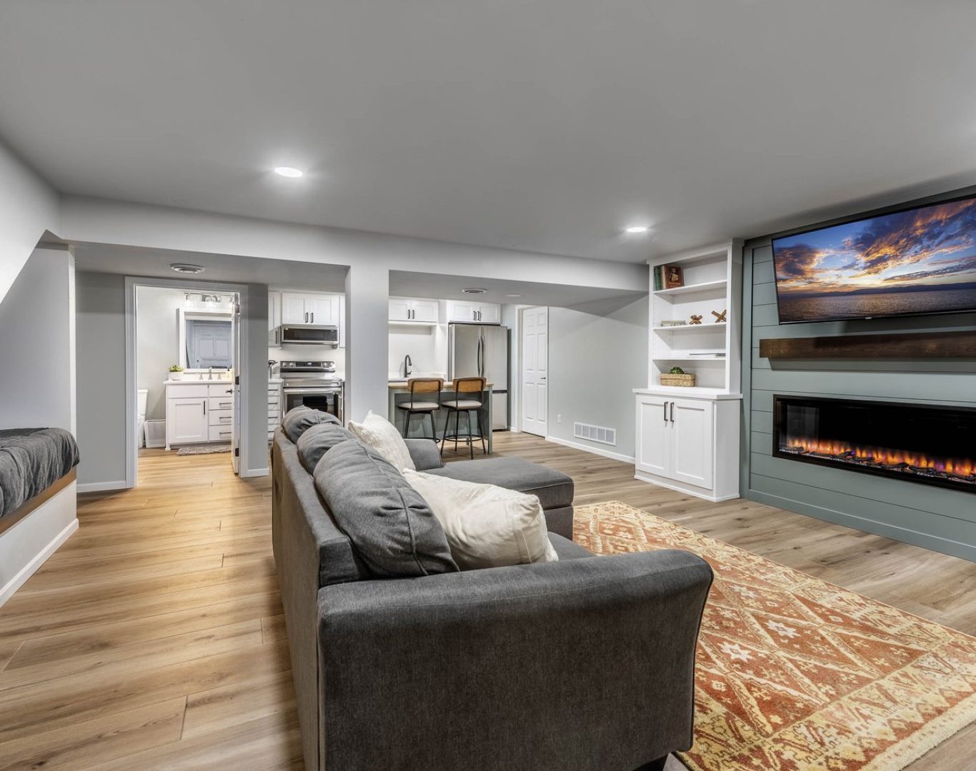 Finished basement renovation with new flooring, recessed lighting, and custom built-ins by Robin Construction in Novi, MI